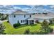 A beautifully landscaped backyard featuring a screened-in lanai, lush green lawn, and mature plantings for privacy and enjoyment at 1443 Bunker Dr, Davenport, FL 33836