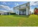 Expansive backyard with lush green lawn and screened patio, perfect for outdoor living and entertaining at 1443 Bunker Dr, Davenport, FL 33836