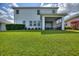 Well-maintained backyard featuring a screened-in patio and manicured lawn with lovely landscaping at 1443 Bunker Dr, Davenport, FL 33836