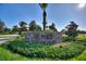 Stone sign for 'The Plaza' set amidst colorful flower beds and lush greenery at 1443 Bunker Dr, Davenport, FL 33836