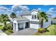 Stunning two-story home with a manicured lawn, stone accents, and a paver driveway at 1443 Bunker Dr, Davenport, FL 33836