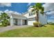 Elegant two-story home with a charming covered porch, two-car garage, and lush landscaping at 1443 Bunker Dr, Davenport, FL 33836