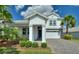 Beautiful two-story home with a well manicured lawn, stone accents, and a two car garage at 1443 Bunker Dr, Davenport, FL 33836