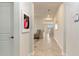 Long hallway with neutral colored walls and tile floors leading to the home's main living areas at 1443 Bunker Dr, Davenport, FL 33836