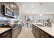 Modern kitchen with stainless steel appliances and views into the dining area at 1443 Bunker Dr, Davenport, FL 33836