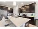 Modern kitchen featuring white quartz countertops, dark cabinets, and stainless steel appliances at 1443 Bunker Dr, Davenport, FL 33836