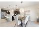 Open-concept kitchen with stainless steel appliances, dark cabinets, white countertops, and dining area at 1443 Bunker Dr, Davenport, FL 33836