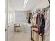 Functional laundry room with washer, dryer, and storage shelving at 1443 Bunker Dr, Davenport, FL 33836