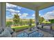 Inviting screened-in patio featuring stylish furniture and scenic views of the surrounding landscaping at 1443 Bunker Dr, Davenport, FL 33836