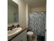 Bathroom featuring granite countertop, a blue-themed shower curtain, and neutral flooring at 1648 Heart Bar Rd, Kissimmee, FL 34744