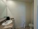 Well lit bathroom featuring a granite countertop and a white bowl sink at 1648 Heart Bar Rd, Kissimmee, FL 34744