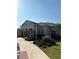 Community building showcasing lush landscaping, gray exterior, and brick support columns at 1648 Heart Bar Rd, Kissimmee, FL 34744