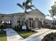 A community clubhouse featuring a welcoming entrance, stone accents, and well-manicured landscaping at 1648 Heart Bar Rd, Kissimmee, FL 34744