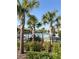 Resort-style community pool area with palm trees, lounge chairs and shade pavilions at 1648 Heart Bar Rd, Kissimmee, FL 34744