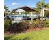 Community pool offers shaded tables and lounge chairs for residents to enjoy at 1648 Heart Bar Rd, Kissimmee, FL 34744