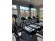 The gym features treadmills and an elliptical with large windows providing views of the pool and surrounding area at 1648 Heart Bar Rd, Kissimmee, FL 34744