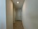 Hallway with a light tile floor and neutral-colored walls at 1648 Heart Bar Rd, Kissimmee, FL 34744