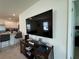 Comfortable living room with a large wall-mounted TV and view into the kitchen at 1648 Heart Bar Rd, Kissimmee, FL 34744