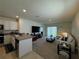 Open-concept living room featuring modern furnishings and sliding glass door to the backyard at 1648 Heart Bar Rd, Kissimmee, FL 34744