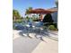 Outdoor lounge area with plenty of seating, umbrellas, and palm tree landscaping at 1648 Heart Bar Rd, Kissimmee, FL 34744
