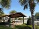 Community pool area featuring a picnic shelter, lounge chairs, and refreshing atmosphere at 1648 Heart Bar Rd, Kissimmee, FL 34744