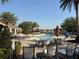 Resort-style community pool area features tables, seating, and umbrellas for lounging at 1648 Heart Bar Rd, Kissimmee, FL 34744