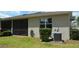 Exterior view of back of house with AC unit, window and screened-in porch at 1859 Shumard Ave, St Cloud, FL 34771