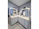 Bathroom featuring double vanity with white cabinets, updated fixtures, and tile floors at 1859 Shumard Ave, St Cloud, FL 34771