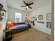 Cozy bedroom with a daybed, ceiling fan, and decorative music-themed wall decor at 1859 Shumard Ave, St Cloud, FL 34771