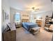 Bedroom with a bed, dresser, and bookcase; the room is decorated with neutral colors at 1859 Shumard Ave, St Cloud, FL 34771