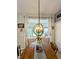 Cozy dining area with a wooden table, decorative chandelier, and bright window views at 1859 Shumard Ave, St Cloud, FL 34771