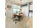 Cozy dining area with a wooden table, a window with blinds, and a stylish hanging light fixture at 1859 Shumard Ave, St Cloud, FL 34771