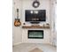 Cozy corner fireplace with a modern design, built-in shelving, and TV mount at 1859 Shumard Ave, St Cloud, FL 34771