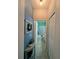 Hallway with blue accent wall leading to a bathroom and closet at 1859 Shumard Ave, St Cloud, FL 34771