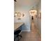 Hallway with a tiled floor leading to arched doorways and plenty of lighting at 1859 Shumard Ave, St Cloud, FL 34771