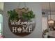 Charming 'Welcome To Our Home' sign with leaves and bow, enhancing the inviting atmosphere at 1859 Shumard Ave, St Cloud, FL 34771