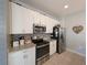 Well-equipped kitchen with stainless steel appliances, granite counters, and bright white cabinetry at 1859 Shumard Ave, St Cloud, FL 34771