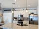 Bright kitchen with stainless steel appliances, granite countertops, and stylish pendant lighting above the island at 1859 Shumard Ave, St Cloud, FL 34771
