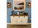 Interior view showcasing a decorative cabinet with painting, flowers, and elegant accents at 1859 Shumard Ave, St Cloud, FL 34771