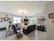 Comfortable living room with a fireplace, tile flooring, and natural light streaming through the windows at 1859 Shumard Ave, St Cloud, FL 34771