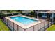 Community pool featuring sparkling water, paved deck, and secure fencing at 1859 Shumard Ave, St Cloud, FL 34771