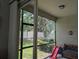 View from screened porch with a bench and a slide looking into the backyard at 1859 Shumard Ave, St Cloud, FL 34771