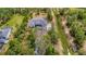 Expansive aerial view of home featuring a long driveway, attached garage, large yard, and surrounding trees at 19182 Seaview St, Orlando, FL 32833