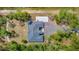 This aerial view shows the home's layout, driveway, and surrounding landscape and trees at 19182 Seaview St, Orlando, FL 32833