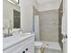 Well-lit bathroom features a marble vanity and walk-in shower with stone tile at 19182 Seaview St, Orlando, FL 32833