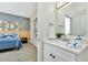 Bright bathroom features white cabinetry, marble countertops and opens to the bedroom at 19182 Seaview St, Orlando, FL 32833