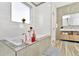 Modern bathroom with soaking tub, white tiled walls, and a stylish vanity at 19182 Seaview St, Orlando, FL 32833