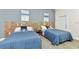 This well-lit bedroom offers two twin beds and sleek wood-look floors at 19182 Seaview St, Orlando, FL 32833