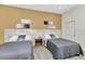 This well-lit bedroom offers two twin beds and sleek wood-look floors at 19182 Seaview St, Orlando, FL 32833