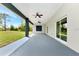 This is a covered patio with views of the backyard and access to the home's interior at 19182 Seaview St, Orlando, FL 32833